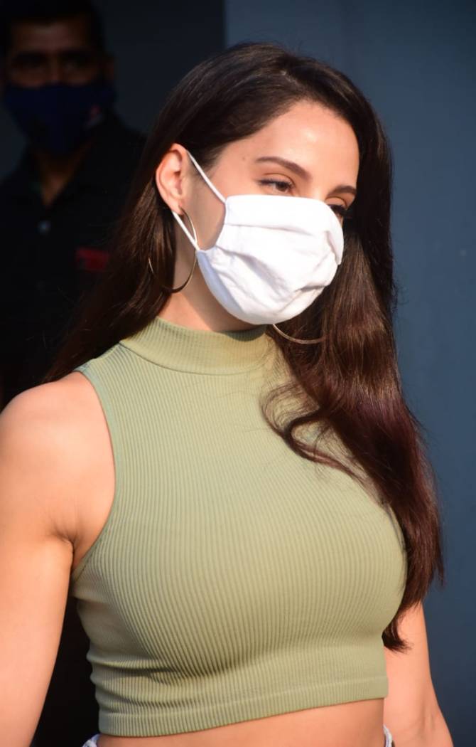 Nora Fatehi was clicked at producer Vashu Bhagnani's office in Juhu, Mumbai. The Batla House star looked chic in her green crop top and denim for the outing.