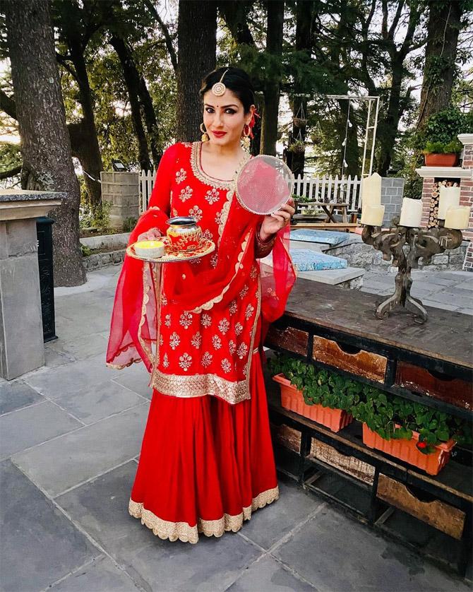 Dressed in a red traditional salwar suit, Raveena Tandon shared a couple of pictures waiting for the moon to show up. She also penned a note on the Karva Chauth celebration this year. She wrote, 
