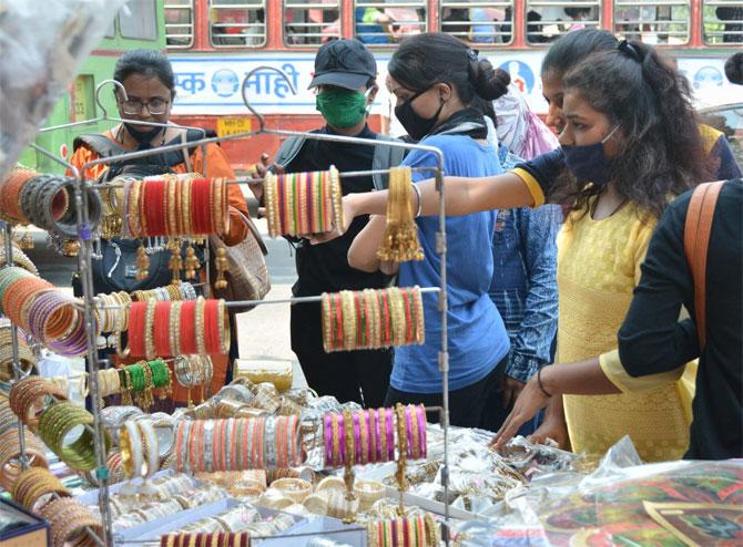 Although the global pandemic has hit the festival celebrations, it has failed to dampen the festive mood.
In picture: Women buying jewellery from a stall.
