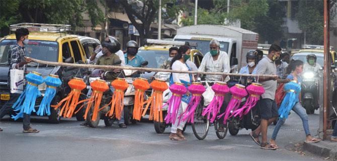 In picture: Youngsters cross Dadar's Sena Bhavan signal with lanterns made for sale for the Diwali festival.
