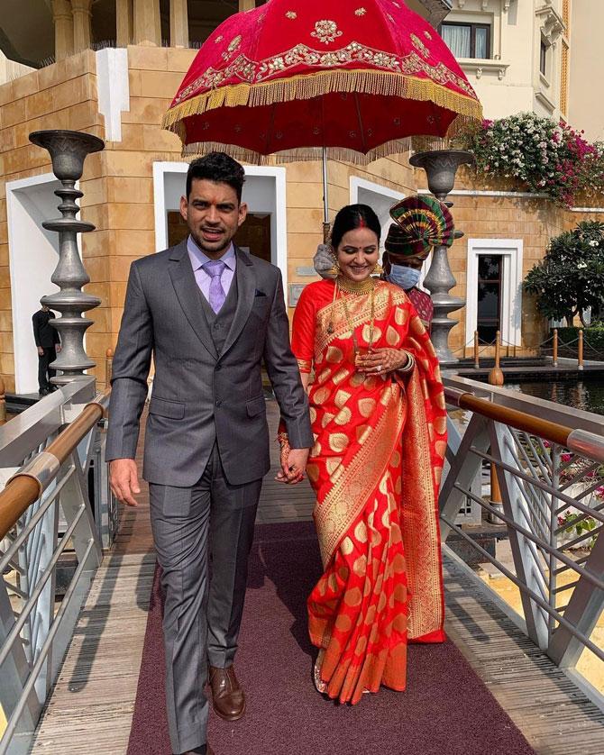 Rangoli Chandel posted this picture, where Aksht can be seen all suited-up, while the bride looked resplendent in a red saree. She wrote, 
