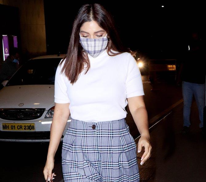 Bhumi Pednekar sported a white top and checkered pant as she arrived at the Mumbai airport along with her sister Samiksha. Bhumi is currently promoting her upcoming film Durgamati, which is set to release on December 11. All pictures/Yogen Shah