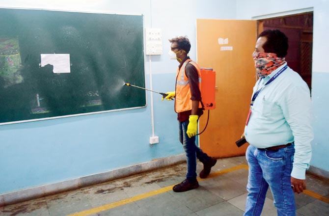 Civic staff sanitise a BMC-run school in Mumbai Central. Pic/Bipin Kokate