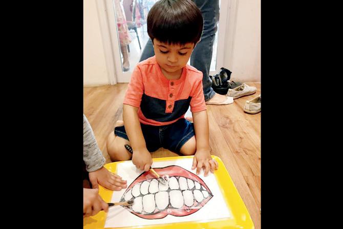 A child learns the importance of brushing teeth