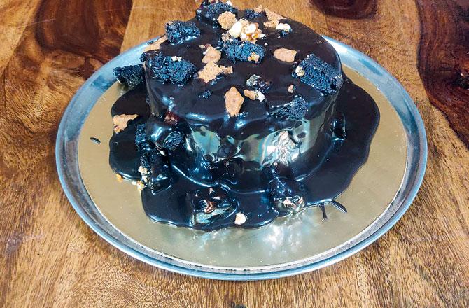 A decadent chocolate cake dunked in ganache is on your plate