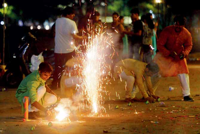 People burst firecrackers on the occasion of Bhaubeej at Gymkhana lane opposite Marine Drive last year. FILE PIC