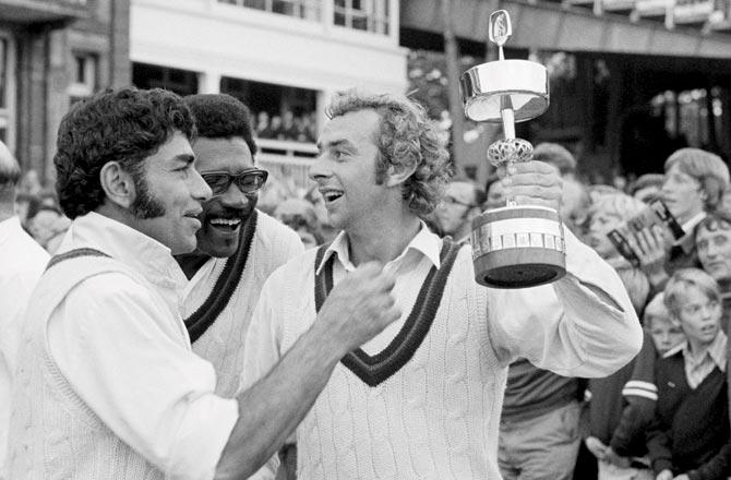 Lancashire captain David Lloyd (right) holds the Gillette Cup as teammates Farokh Engineer (left) and Clive Lloyd laugh away while celebrating the county
