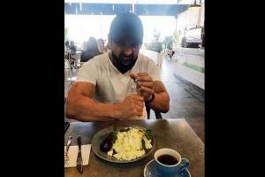 John Abraham begins his day by crushing on some protein