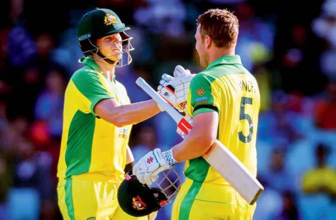 Aaron Finch (right) celebrates his century with Steven Smith