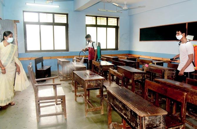 Corporator Urmila Panchal oversaw the sanitisation of a civic school in Dadar East on Friday. Pic/Suresh Karkera