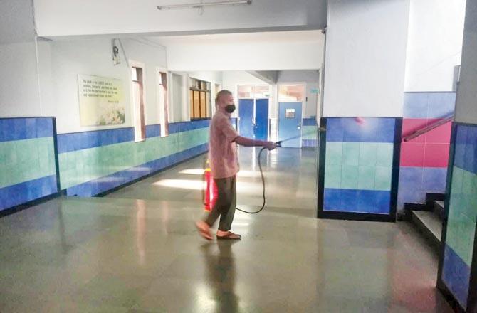 A worker sanitises St JosephHigh School in Panvel