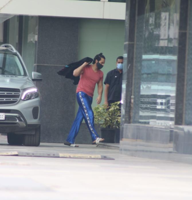Varun Dhawan is a busy boy nowadays. And this picture is proof. The actor was clicked at Karan Johar's Dharma Productions office. For the outing, the actor wore a red t-shirt and blue jeans.