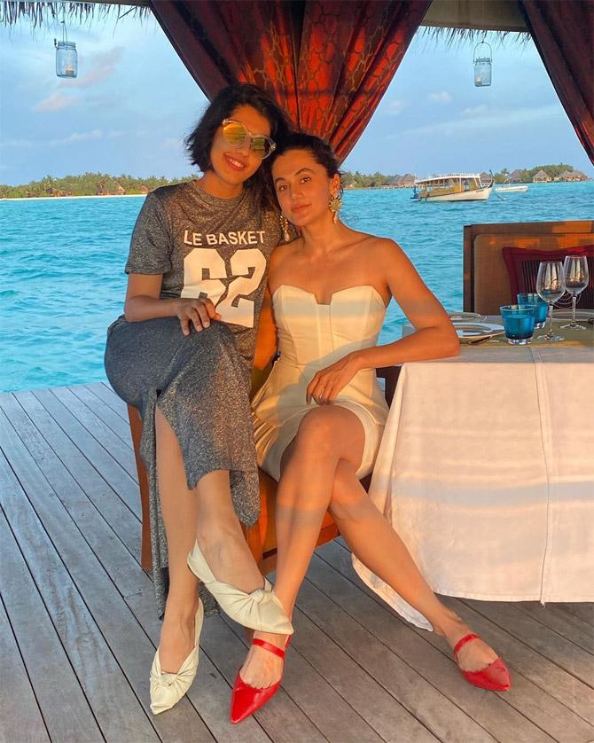 Taapsee Pannu took to Instagram to share the picture which shows the two sisters seated against the backdrop of a serene blue sea. While Taapsee is seen all decked up in a white tube dress, her sister is seen wearing a grey coloured t-shirt dress.