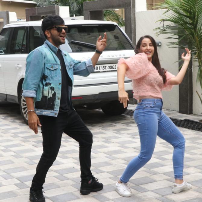 The duo was at the T-series for two consecutive days. For the first day, Nora donned a pink top and denim, while the Punjabi singer opted for a black t-shirt, jeans, and a denim jacket.