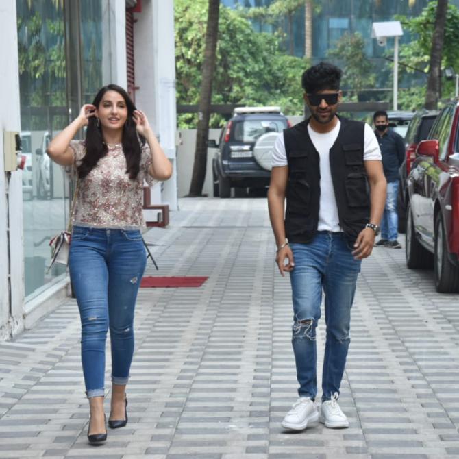 The next day, Nora changed into a white top and denim along with a pair of black heels. On the other hand, Randhawa looked dapper in his white t-shirt, black jacket and ripped jeans. He completed his look with a pair of white sneakers.