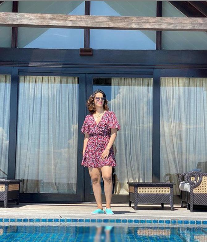 Saina Nehwal poses in a purple short dress outside her hotel room which overlooks their private swimming pool.