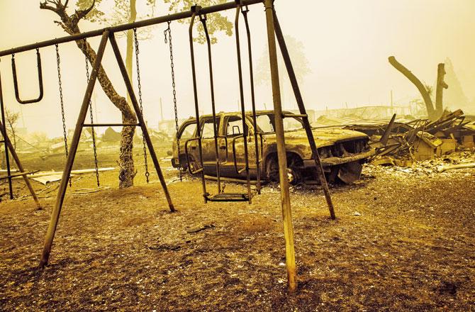A charred swing set and car are seen after the passage of the Santiam Fire in Gates, Oregon, on September 10. Pics/AFP