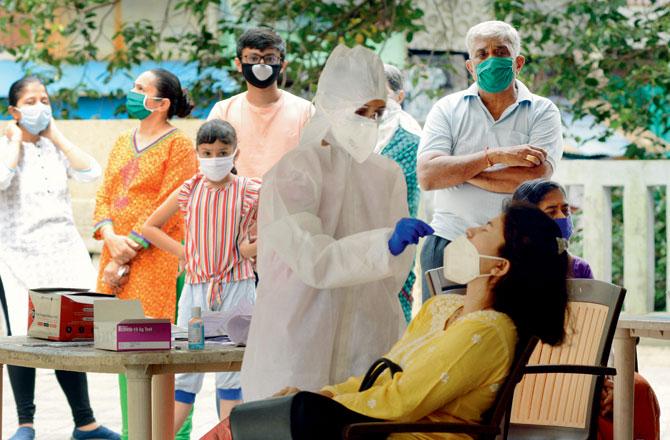 Residents of Anmol Fortune gets tested for COVID-19 at a camp in Thakur Complex, Kandivli, on October 2. File pic/Satej Shinde