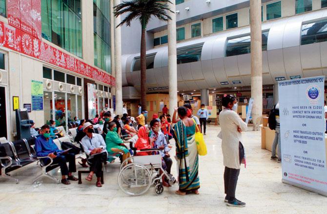 People wait in the reception area of the hospital