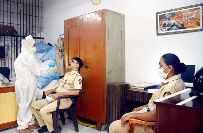 Kandivli police station officers get tested for COVID-19 at an antigen testing camp at SV Road. Pic/Satej Shinde