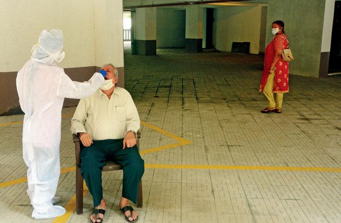 A resident of Anmol Fortune gets tested for COVID-19 at an antigen testing camp at Thakur Complex, Kandivli. Pic/Satej Shinde