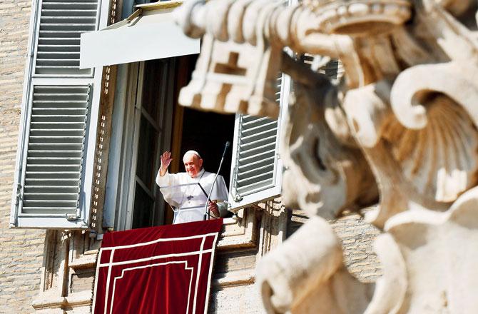 Pope Francis waves to pilgrims in St Peter