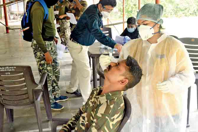 BMC staff conduct an antigen test on a Mumbai police personnel at Police Colony in Ghatkopar East. 