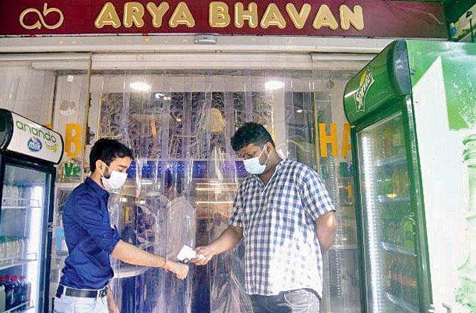 A patron gets his temperature checked at Arya Bhavan restaurant in Matunga East. Pics/Pradeep Dhivar