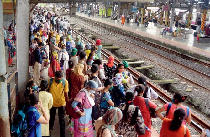Passengers wait on a platform at Kurla, on Monday. Since June, 16 people died after falling off moving trains