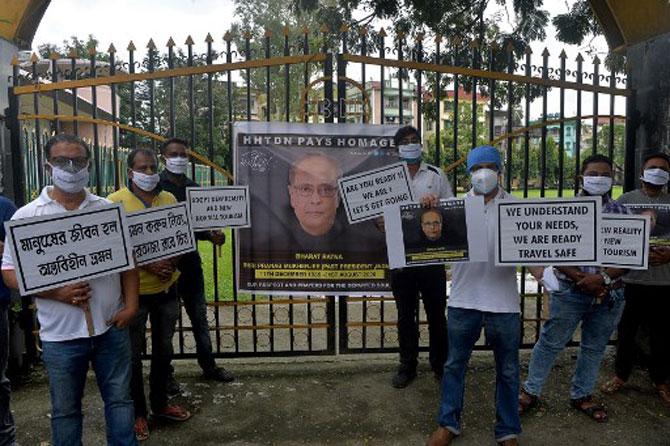 In photo: Indian tour operators and members of Himalayan Hospitality and Tourism Development Network (HHTDN) hold placards as they pay homage to Pranab Mukherjee, in Siliguri.