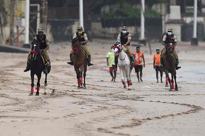 In picture: The mounted unit of Mumbai Police ride on horses while patrolling a deserted beach on the last day of the Ganesh Chaturthi festival in Mumbai.