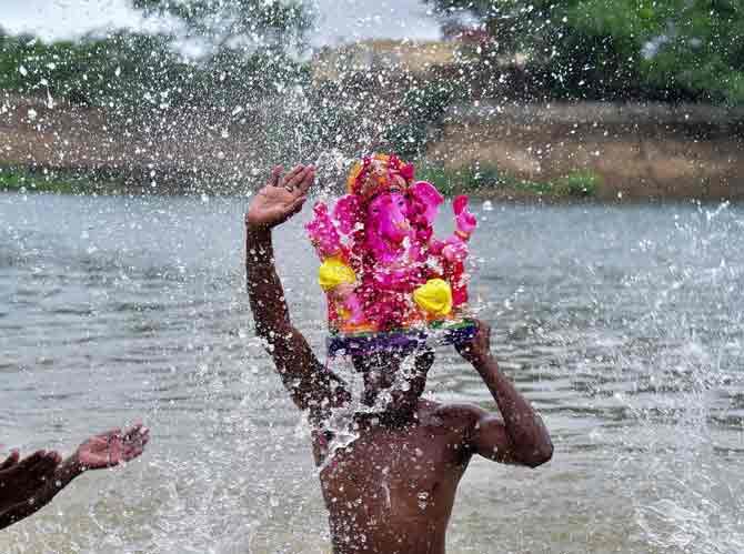 In picture: A devotee carries an idol of Lord Ganesh for immersion in the Devi Kund Sagar at Bikaner in Rajasthan.