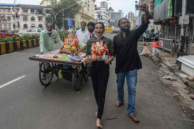 In picture: A devotee clicks a selfie while accompanying others to a pond to immerse the Ganesha idols in Mumbai.