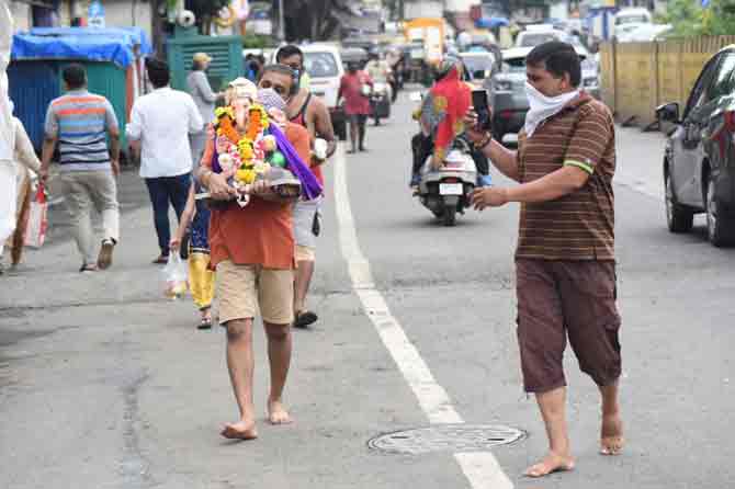 People were asked to perform the rituals at their residences before stepping out for immersion.
In picture: A devotee carries an idol to be immersed at a water pond set up by BMC in Santacruz.