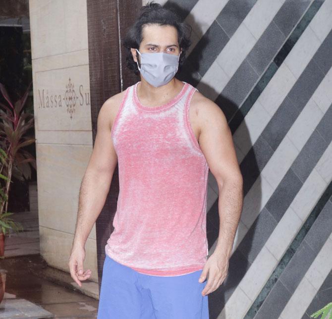 Varun Dhawan to was spotted in Mumbai suburbs, the actor was clicked at a dance studio in Juhu. The actor sported a pink vest, blue shorts and orange coloured shoes as she posed for the photographers. The actor sported a grey coloured face mask.