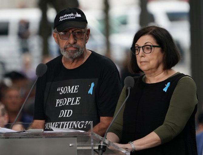 Nic Haros (L) reads the names of victims during the September 11 Commemoration Ceremony at the 9/11 Memorial at the World Trade Center on September 11, 2019, in New York.