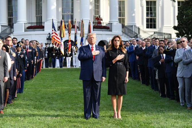 US President Donald Trump and First Lady Melania Trump observe a moment of silence on the South Lawn of the White House to mark the 18th anniversary of the 9/11 attacks, on September 11, 2019, in Washington, DC.