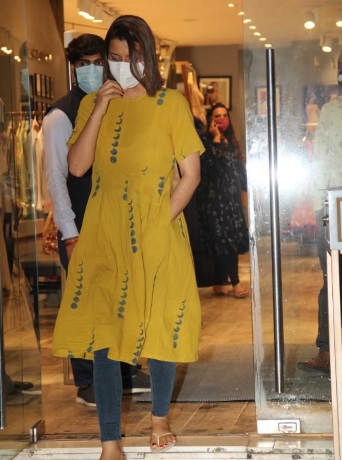 Kangana Ranaut's sister and her manager Rangoli Chandel was clicked by the paparazzi in Bandra, Mumbai. For the outing, she opted for a yellow dress and dark grey leggings. (All pictures: Yogen Shah).
