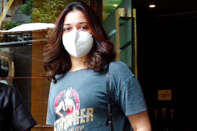 Tamannaah Bhatia was spotted out and about in the suburban Mumbai. The actress was clicked exiting a popular salon. Tamannaah sported a grey printed tee and black shorts with a protective face mask as she stepped out from the salon. All pictures/Yogen Shah