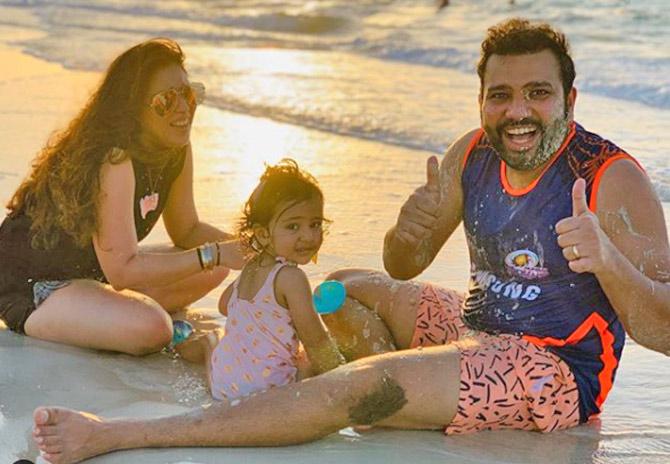 Mumbai Indians captain Rohit Sharma with his wife Ritika Sajdeh and their daughter Samaira at a beach in Dubai.