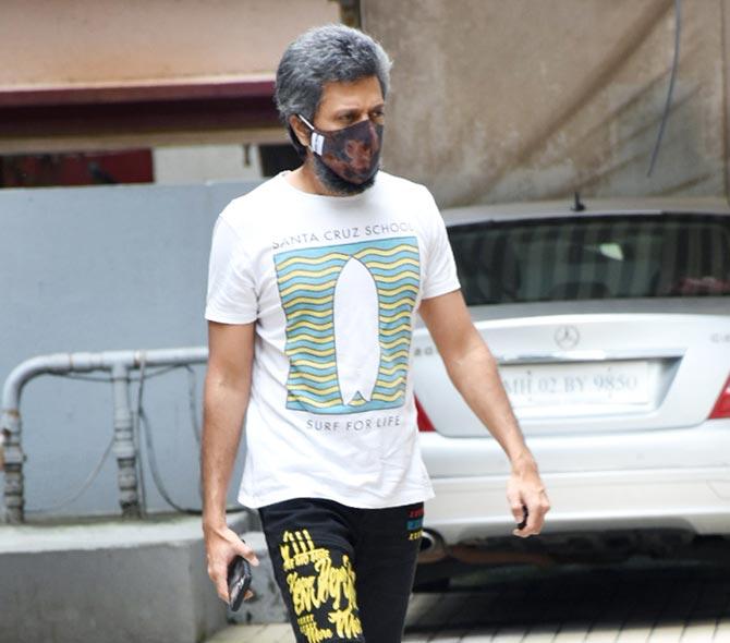 Riteish Deshmukh and wife Genelia Deshmukh were spotted in Bandra, Mumbai. Riteish, who has been sporting a salt and pepper hairstyle for some time now, was clicked wearing a white tee and black track pant with a protective face mask. All pictures/Yogen Shah
