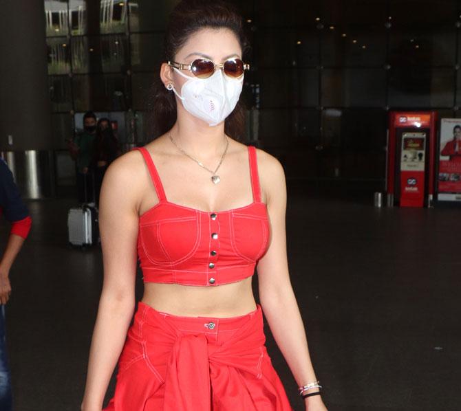 Urvashi Rautela looked stunning in her red denim crop top, matching pant and tied down jacket as she arrived at the Mumbai airport. The Hate Story 3 actress also wore a protective face mask. All pictures/Yogen Shah