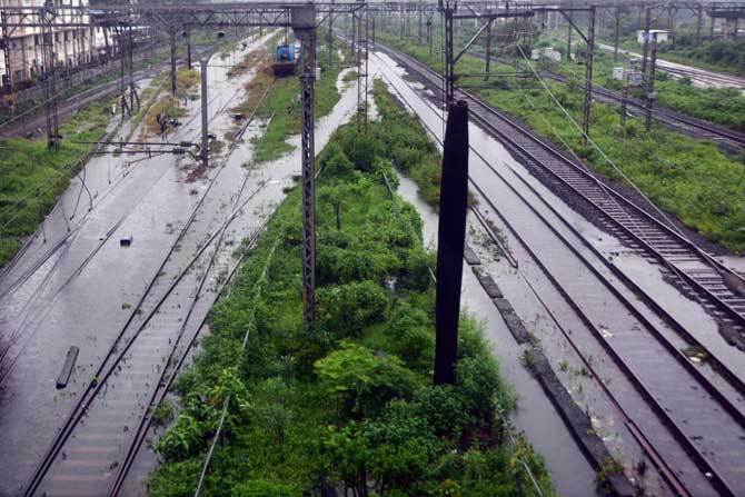 Heavy downpour led to waterlogging in several areas of Mumbai and suburbs
In picture: Water logging on railway tracks between Kurla and Sion. Pic/ Pradeep Dhivar