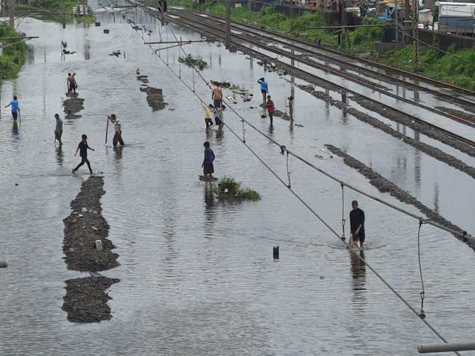 In picture: Water logging on the railway tracks. Train services got disrupted on Central route due to flooding on tracks at few places. Pic/ Pradeep Dhivar