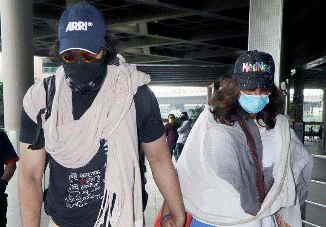 Ali Fazal and Richa Chadha were spotted at the Mumbai airport. The couple took all the precautions as they arrived at the airport. Richa and Ali were dressed casually wore protective face masks, glares and caps. All pictures/Yogen Shah