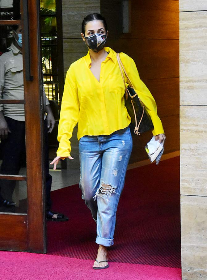 Malaika Arora was snapped at her Bandra residence in Mumbai. The actress, who was seen wearing a yellow shirt, paired with distress denim has recovered from COVID-19. All pictures/Yogen Shah