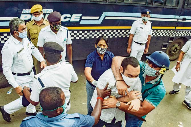 A protester from the Youth Congress is detained by the Kolkata police during a demonstration in Kolkata against the government’s decision to organise competitive exams