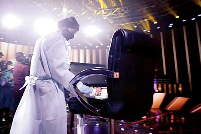 A crew member sanitises Bachchan’s seat;