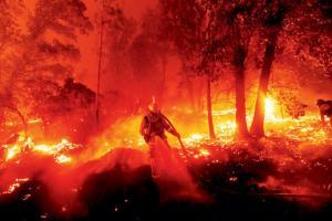 As California burns, winds arrive and lights go out