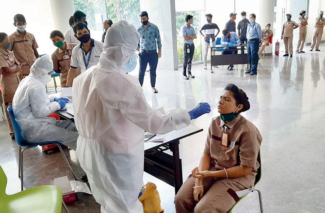 Housekeeping workers get tested for COVID-19 at an antigen testing camp at Oberoi Garden City, Goregaon, on Monday. Pic/Satej Shinde